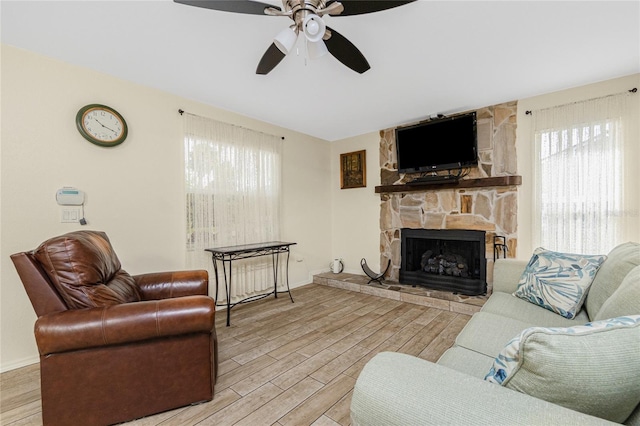 22559 Adorn Ave, Port Charlotte, FL 33952 - living area featuring plenty of natural light, wood finished floors, and a stone fireplace