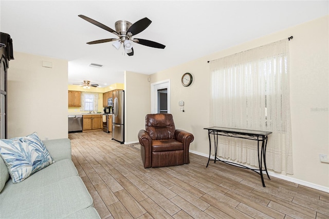 22559 Adorn Ave, Port Charlotte, FL 33952 - living area featuring light wood-style flooring and a ceiling fan