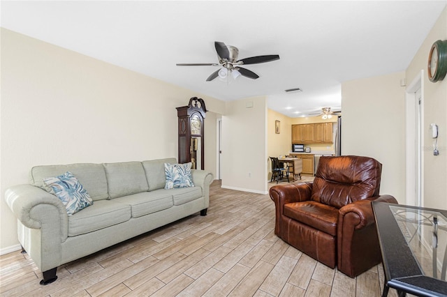 22559 Adorn Ave, Port Charlotte, FL 33952 - living room with a ceiling fan and light wood finished floors