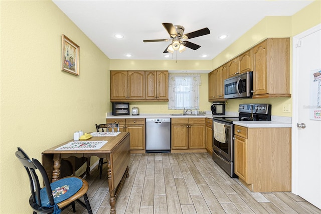 22559 Adorn Ave, Port Charlotte, FL 33952 - kitchen featuring stainless steel appliances, light wood-type flooring, a ceiling fan, light countertops, and recessed lighting