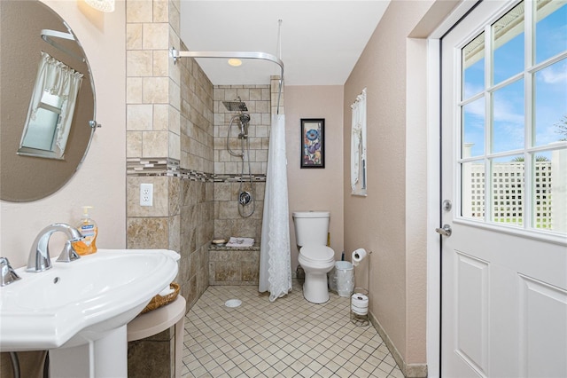 22559 Adorn Ave, Port Charlotte, FL 33952 - bathroom featuring a tile shower, plenty of natural light, and tile patterned floors