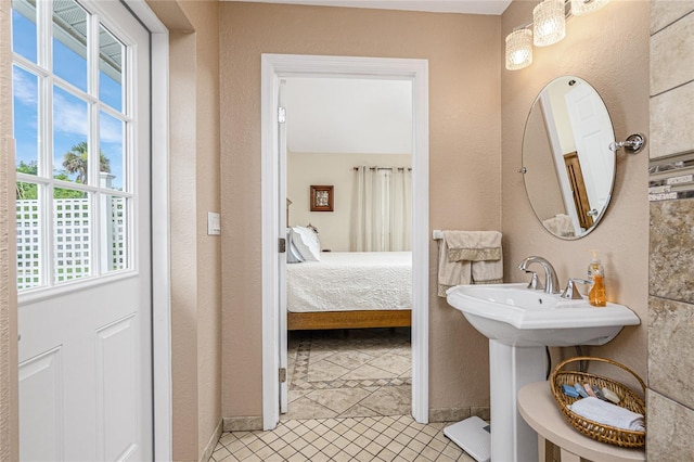 22559 Adorn Ave, Port Charlotte, FL 33952 - ensuite bathroom featuring tile patterned flooring and a textured wall