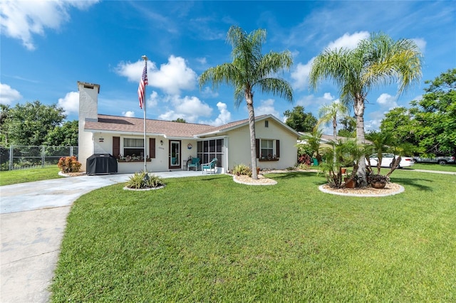 22559 Adorn Ave, Port Charlotte, FL 33952 - back of house featuring concrete driveway, stucco siding, and a chimney