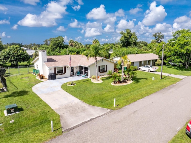 22559 Adorn Ave, Port Charlotte, FL 33952 - ranch-style house with concrete driveway, a chimney, and stucco siding