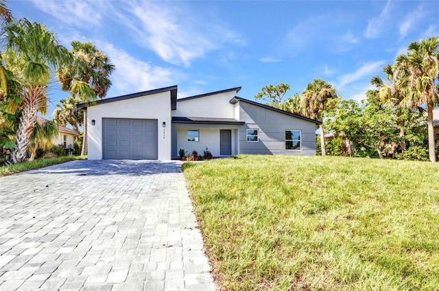 3435 W Price Blvd, North Port, FL 34286 - view of front of house with a garage, decorative driveway, a front lawn, and stucco siding