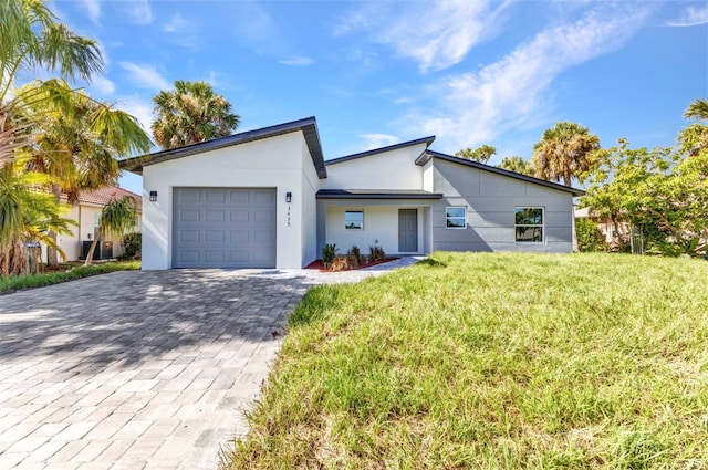 3435 W Price Blvd, North Port, FL 34286 - view of front of home featuring a garage, decorative driveway, a front lawn, and stucco siding