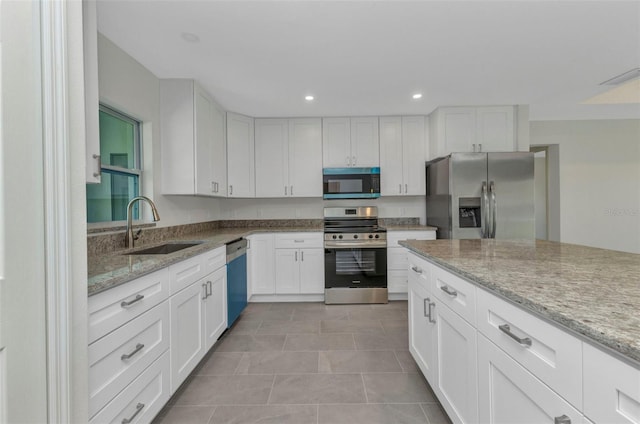 3435 W Price Blvd, North Port, FL 34286 - kitchen featuring stainless steel appliances, white cabinetry, light stone countertops, and recessed lighting