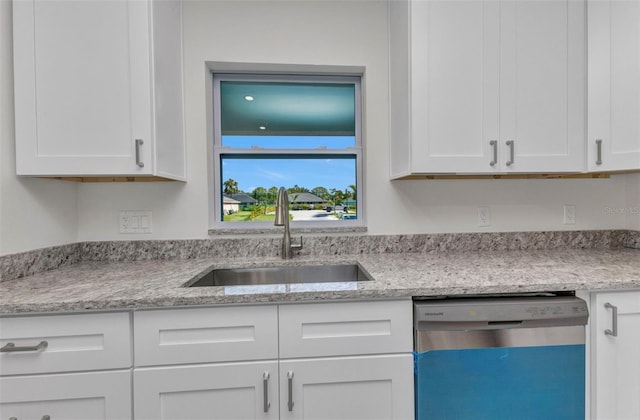 3435 W Price Blvd, North Port, FL 34286 - kitchen with dishwasher, white cabinets, and light stone countertops