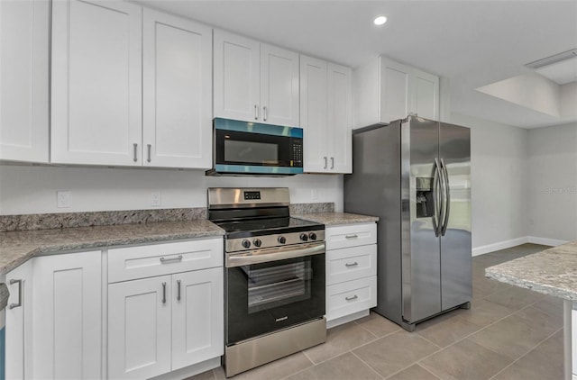 3435 W Price Blvd, North Port, FL 34286 - kitchen with appliances with stainless steel finishes, white cabinets, light tile patterned floors, recessed lighting, and light stone countertops