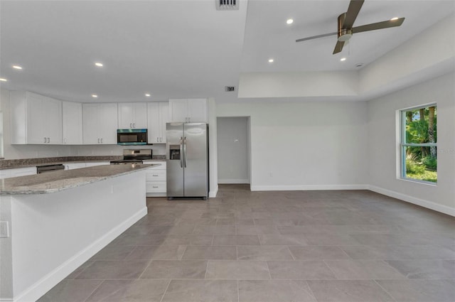 3435 W Price Blvd, North Port, FL 34286 - kitchen featuring appliances with stainless steel finishes, white cabinetry, a ceiling fan, light stone countertops, and recessed lighting