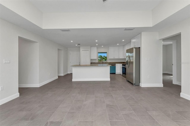 3435 W Price Blvd, North Port, FL 34286 - kitchen with stainless steel fridge, dishwashing machine, white cabinetry, stove, and a center island