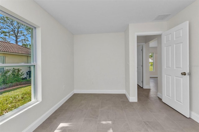 3435 W Price Blvd, North Port, FL 34286 - empty room with plenty of natural light and light tile patterned floors