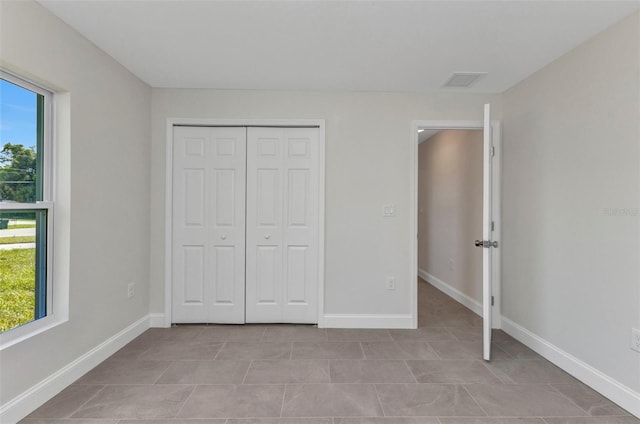 3435 W Price Blvd, North Port, FL 34286 - unfurnished bedroom with light tile patterned flooring and a closet