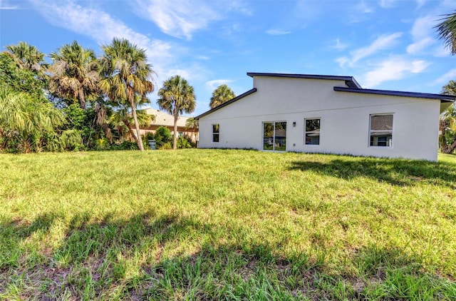 3435 W Price Blvd, North Port, FL 34286 - rear view of house featuring a yard and stucco siding