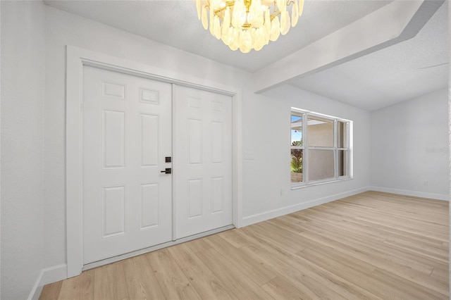 25451 Kowloon Ln, Punta Gorda, FL 33983 - entrance foyer with a chandelier and light wood-style floors