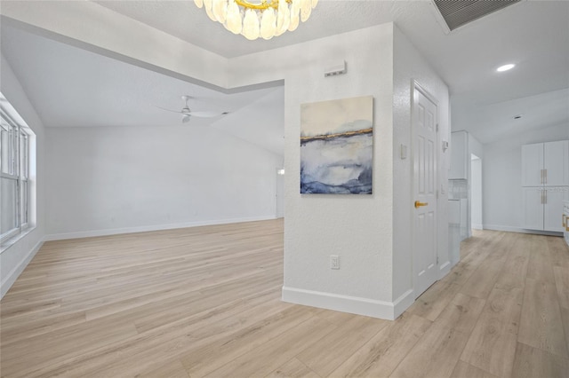 25451 Kowloon Ln, Punta Gorda, FL 33983 - corridor with lofted ceiling, light wood-style flooring, a chandelier, and recessed lighting