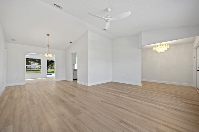 25451 Kowloon Ln, Punta Gorda, FL 33983 - unfurnished living room with a chandelier, a ceiling fan, light wood-style flooring, and high vaulted ceiling