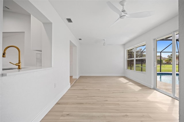 25451 Kowloon Ln, Punta Gorda, FL 33983 - spare room featuring a ceiling fan and light wood-type flooring