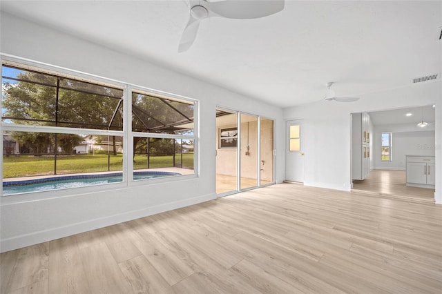 25451 Kowloon Ln, Punta Gorda, FL 33983 - unfurnished living room with ceiling fan and light wood-style floors