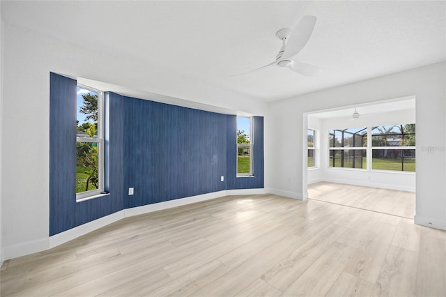 25451 Kowloon Ln, Punta Gorda, FL 33983 - unfurnished room with ceiling fan, wood finished floors, and plenty of natural light