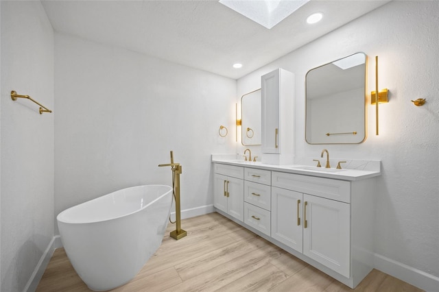 25451 Kowloon Ln, Punta Gorda, FL 33983 - full bath featuring a skylight, double vanity, a soaking tub, wood finished floors, and recessed lighting