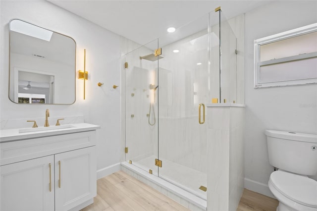 25451 Kowloon Ln, Punta Gorda, FL 33983 - full bathroom with wood finished floors, vanity, a shower stall, and ceiling fan