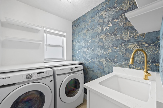 25451 Kowloon Ln, Punta Gorda, FL 33983 - laundry room featuring separate washer and dryer, wallpapered walls, and a textured ceiling