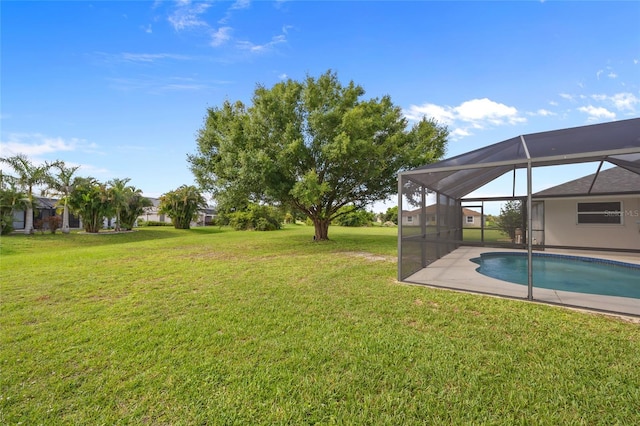 25451 Kowloon Ln, Punta Gorda, FL 33983 - view of green lawn featuring an outdoor pool, a lanai, and a patio area