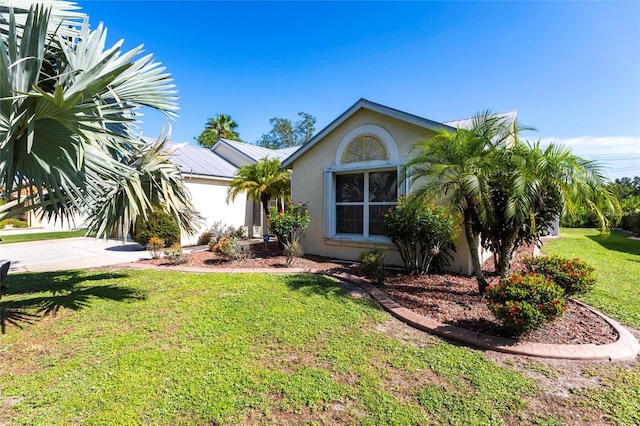27102 Harbour Oaks Blvd, Punta Gorda, FL 33983 - view of front of home with stucco siding and a front lawn