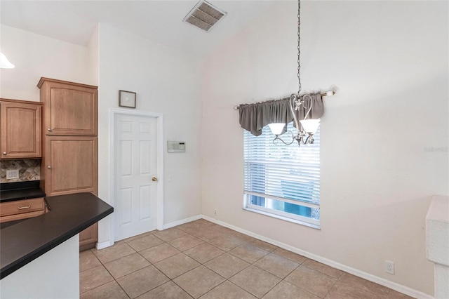 27102 Harbour Oaks Blvd, Punta Gorda, FL 33983 - unfurnished dining area with a chandelier, light tile patterned floors, and vaulted ceiling