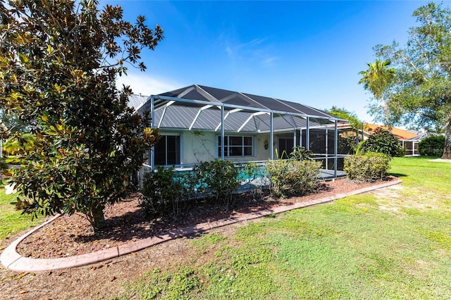 27102 Harbour Oaks Blvd, Punta Gorda, FL 33983 - rear view of house with a yard and glass enclosure