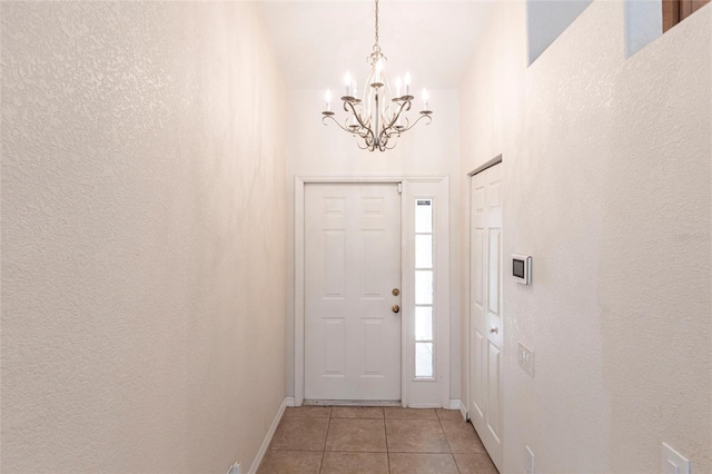 27102 Harbour Oaks Blvd, Punta Gorda, FL 33983 - entrance foyer with a chandelier, light tile patterned floors, and a textured wall