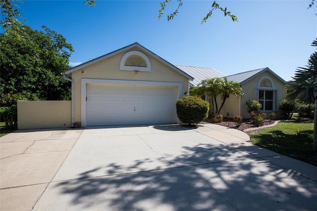27102 Harbour Oaks Blvd, Punta Gorda, FL 33983 - ranch-style home featuring stucco siding, a standing seam roof, concrete driveway, and a metal roof