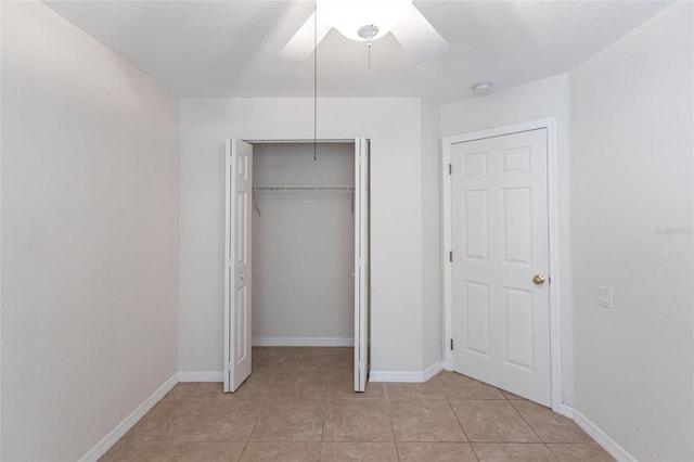 27102 Harbour Oaks Blvd, Punta Gorda, FL 33983 - unfurnished bedroom with a closet, light tile patterned flooring, and a ceiling fan