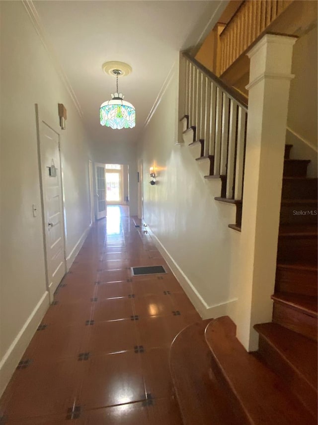 606 E Oak St, Arcadia, FL 34266 - hallway featuring ornamental molding, stairway, and tile patterned floors