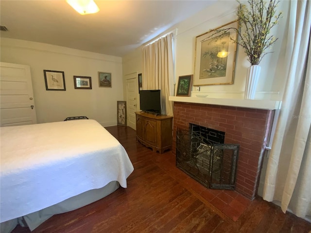 606 E Oak St, Arcadia, FL 34266 - bedroom with dark wood finished floors and a fireplace