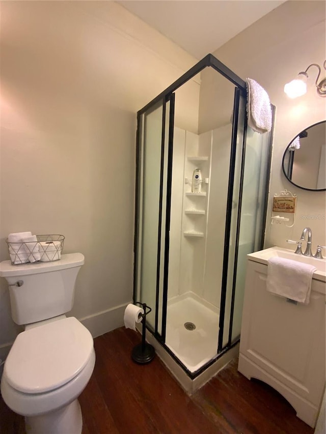 606 E Oak St, Arcadia, FL 34266 - bathroom with wood finished floors, a stall shower, and vanity