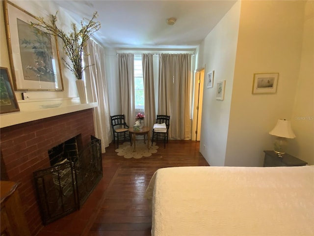 606 E Oak St, Arcadia, FL 34266 - bedroom with dark wood-type flooring and a brick fireplace