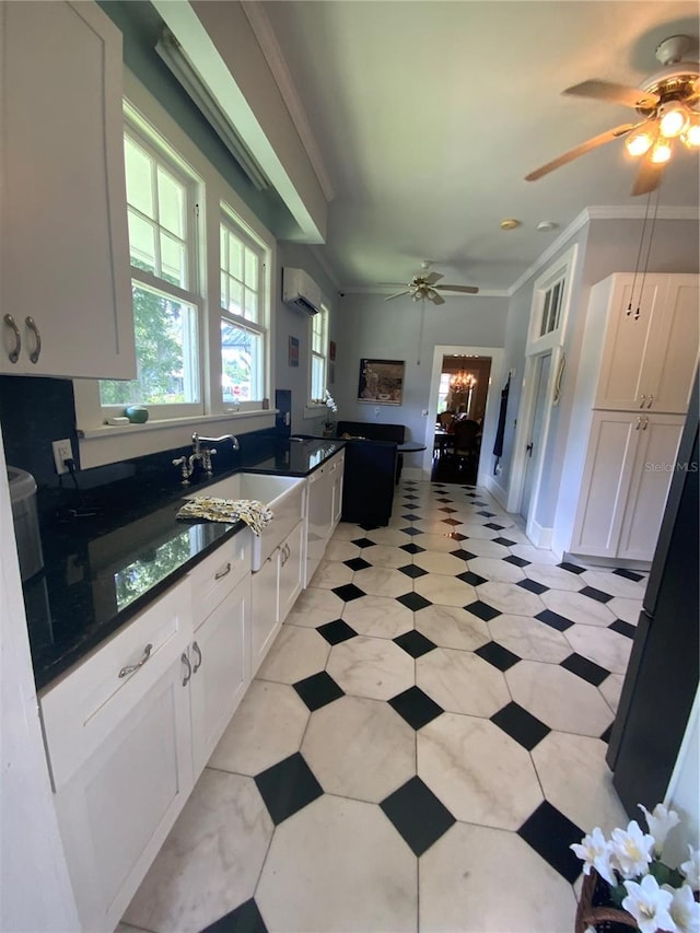 606 E Oak St, Arcadia, FL 34266 - kitchen with ceiling fan, an AC wall unit, white cabinetry, and crown molding