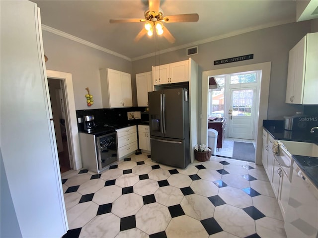 606 E Oak St, Arcadia, FL 34266 - kitchen with stainless steel fridge with ice dispenser, white cabinets, ceiling fan, dark countertops, and white dishwasher
