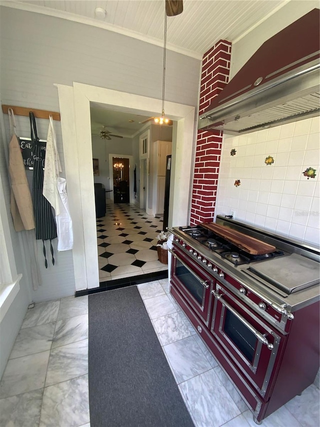 606 E Oak St, Arcadia, FL 34266 - kitchen with wall chimney range hood, crown molding, ceiling fan, tasteful backsplash, and hanging light fixtures