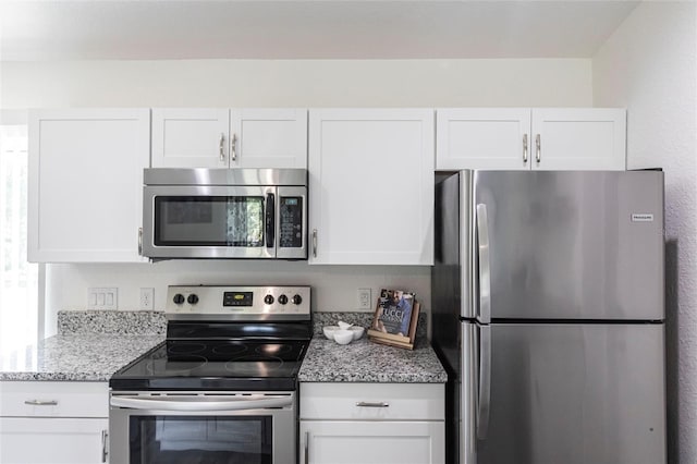 1710 Blackwood Cir, North Port, FL 34288 - kitchen featuring stainless steel appliances, white cabinets, and light stone counters