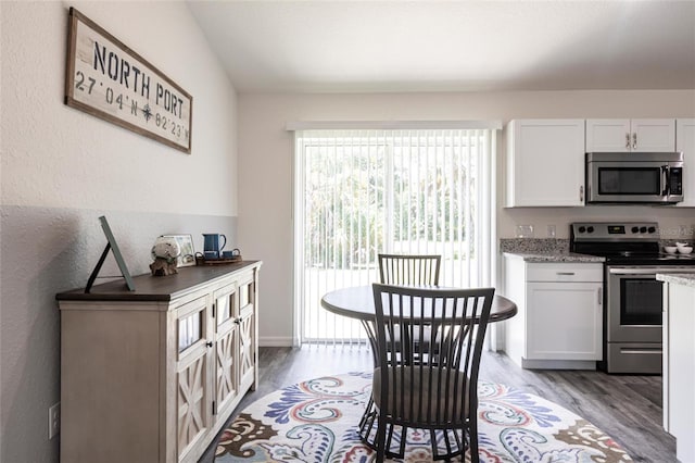 1710 Blackwood Cir, North Port, FL 34288 - dining area featuring light wood finished floors and a textured wall