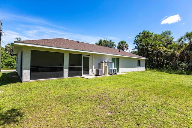 1710 Blackwood Cir, North Port, FL 34288 - back of property featuring a lawn, stucco siding, and a sunroom