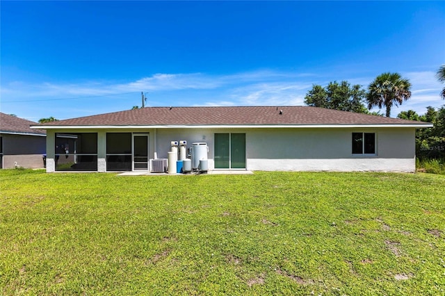 1710 Blackwood Cir, North Port, FL 34288 - rear view of property featuring stucco siding, a yard, and a sunroom