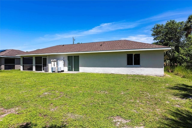 1710 Blackwood Cir, North Port, FL 34288 - back of property with stucco siding and a yard