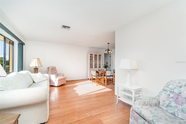 3425 Magnolia Way, Punta Gorda, FL 33950 - living area featuring light wood-style flooring and a chandelier