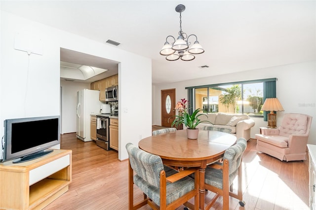 3425 Magnolia Way, Punta Gorda, FL 33950 - dining space featuring light wood-type flooring and a chandelier