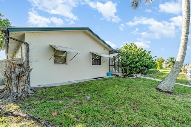 3425 Magnolia Way, Punta Gorda, FL 33950 - view of side of home with stucco siding and a yard