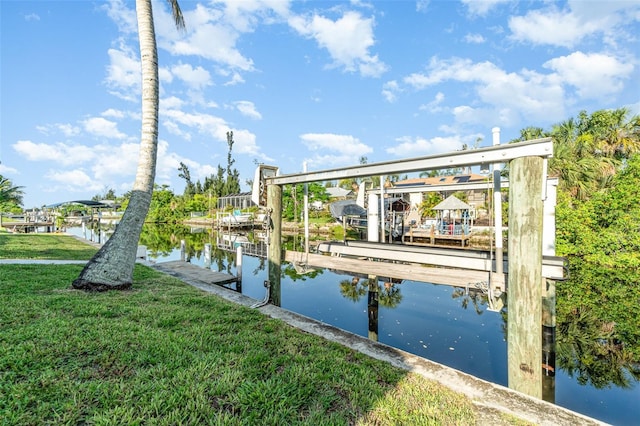 3425 Magnolia Way, Punta Gorda, FL 33950 - dock area featuring boat lift, a water view, and a lawn